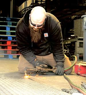 Tech welding on a dock