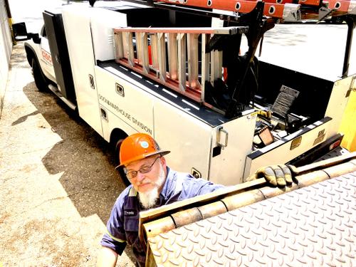 Tech installing dock leveler